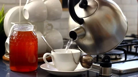 The kettle is boiling and the girl is making tea Stock Footage 64576533