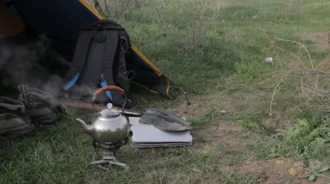 Kettle boiling on the hearth next to the tent Stock Footage 61907364