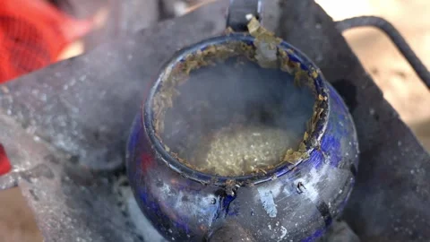 Kettle boiling tea with handmade stove on the beach Stock Footage 305186506