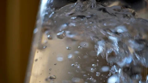 Kettle boiling. Water bubbles circulating in kettle. Slow motion close-up shot Video stock 118436290