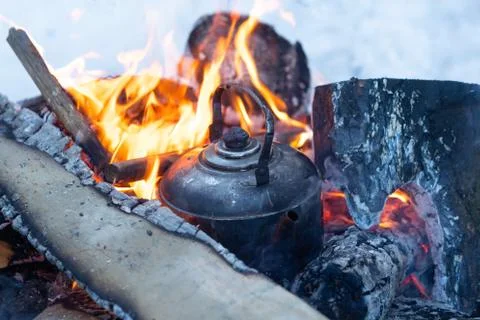 Kettle boils on fire campfire Stock Photos
