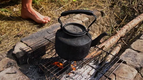 Kettle Boils on an Open Fire During the Day Stock Footage 252805883