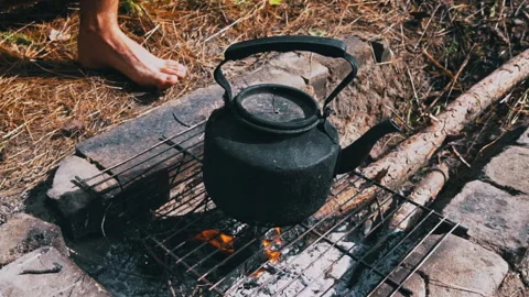 Kettle Boils on an Open Fire During the Day Stock Footage 252808217