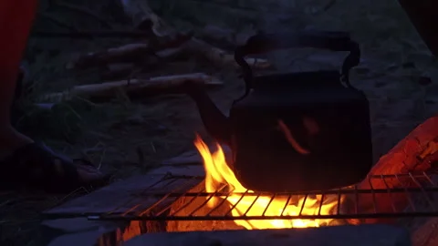 Kettle Boils on an Open Fire at Night Stock Footage 250239336