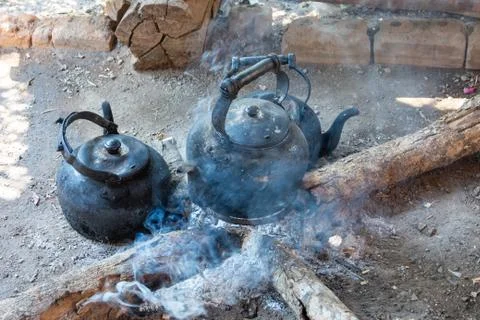 Kettle on campfire Stock Photos