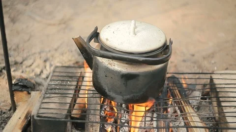 The kettle on the campfire is warm. Video stock 94026619
