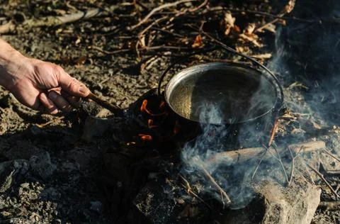 Kettle on charcoal fire. Stock Photos