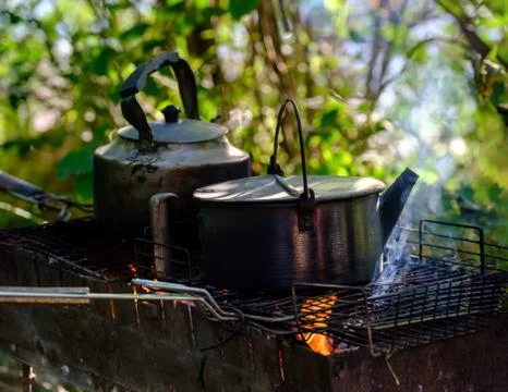 Kettle on the fire fire for tea and coffee. Hot and aromatic coffee with kettle Photos