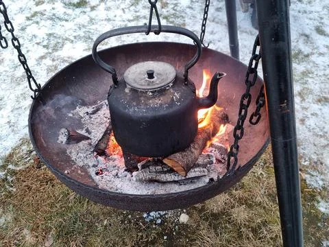 Kettle on the fire outside in winter Stock Photos