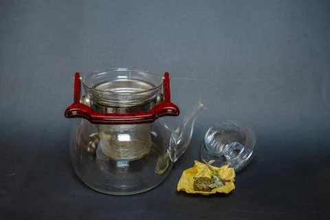 A kettle next to pressed green tea with mint. Stock Photos