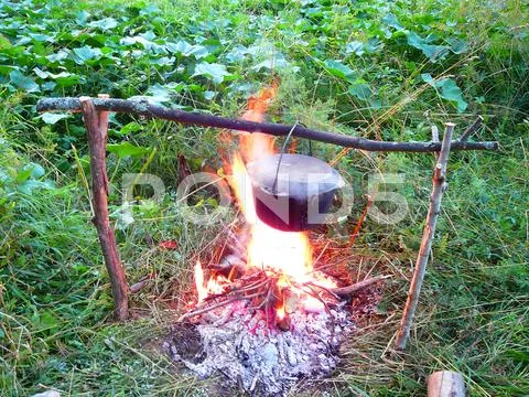 Kettle over the campfire Stock Photos