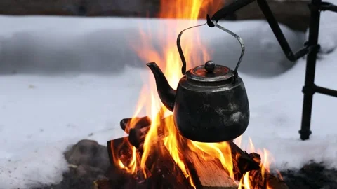Kettle over an open fire in winter. Burning wood Stock Footage 147044261