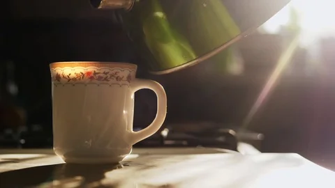 Kettle pouring boiling water into a cup. Slowmotion Stock Footage 85085593