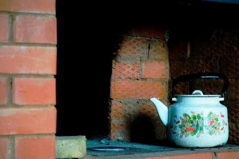 Kettle in the Russian old red brick oven. Stock Photos