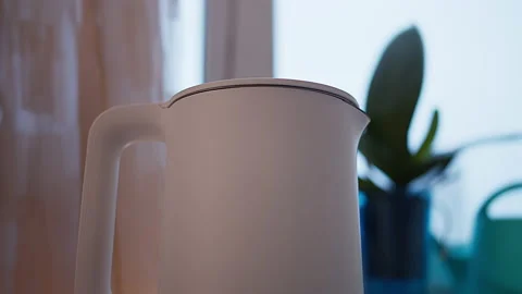 The kettle stands against the background of a light window Stock Footage 150895232