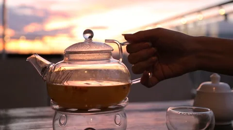 Kettle with tea on the table in a cafe sunset Stock-Footage 67512314