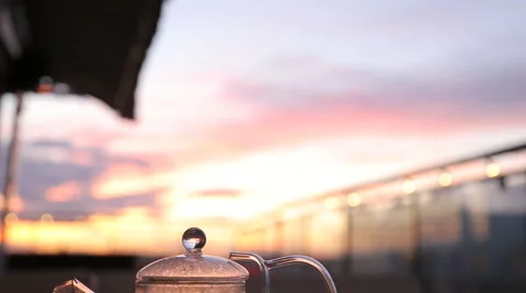 Kettle with tea on the table in a cafe sunset Stock Footage 67512336