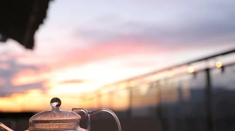 Kettle with tea on the table in a cafe sunset Stock-Footage 67512397