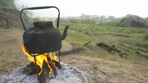 A kettle of water being boiled over fire Stock Footage 89770049