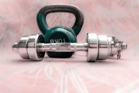 Kettlebell and dumbbell on patterned surface Stock Photos