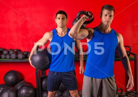 Kettlebell and weighted ball workout gym men Stock Photos