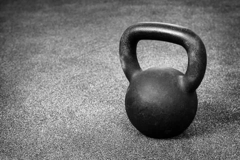 Kettlebell on gray floor Stock Photos
