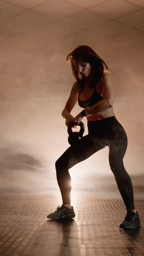 Kettlebell training to increase strength aerobic performance. Woman performs Video stock 272639418