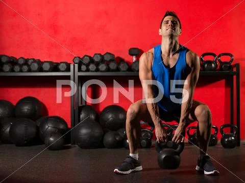 Kettlebell workout training man at gym Stock Photos