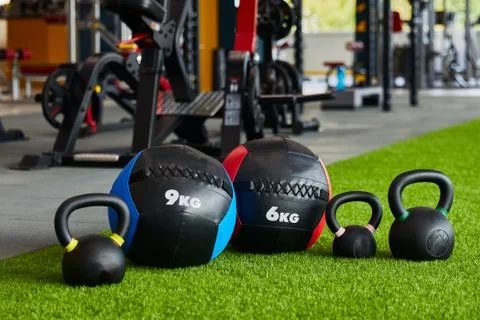 Kettlebells of different sizes and different weights are in a row, close-up, gym Stock Photos