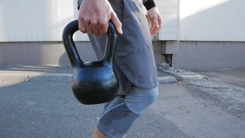 Kettlebells exercises outdoors Stock Footage 97532375