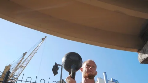 Kettlebells exercises outdoors Stock Footage 97532642