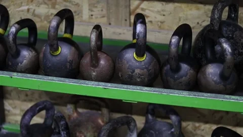 Kettlebells on a shelf in the gym Stock Footage 169586938