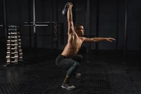 Kettlebells swing exercise man workout at gym. Crossfit training Stock Photos