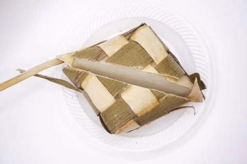 A ketupat split in half on a plastic plate, photo taken from above Stock Photos