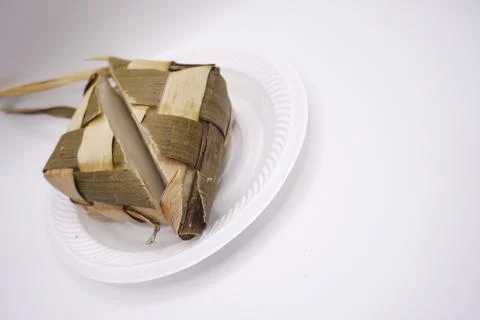 A ketupat that is split in half on a plastic plate, photo taken from the side Foto stock