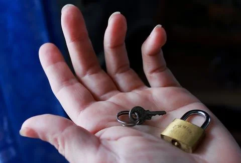 Key and lock on the palm Stock Photos