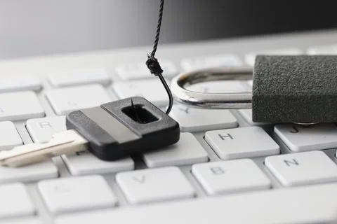 Key and lock on white computer keyboard closeup Stock Photos