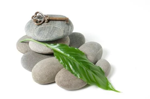 Key and a pile of pebbles Stock Photos