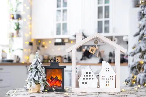 Key and tiny house of a small size on cozy home with Christmas decor on tab.. Foto stock