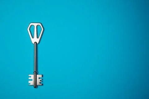 Key on blue background. Minimal creative style Stock Photos