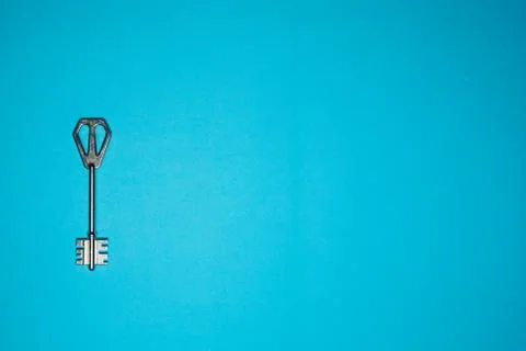 Key on blue background. Minimal creative style Stock Photos