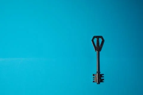 Key on blue background. Minimal creative style Stock Photos