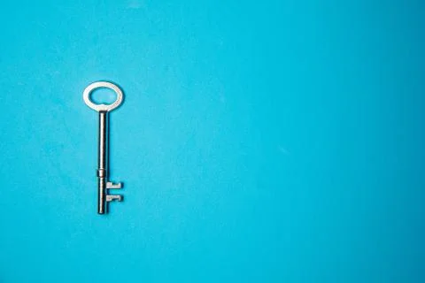 Key on blue background. Minimal creative style Stock Photos