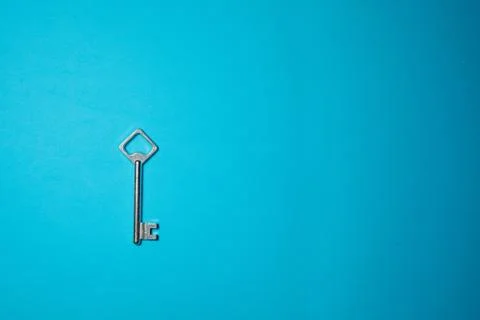 Key on blue background. Minimal creative style Stock Photos