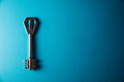 Key on blue background. Minimal creative style Stock Photos
