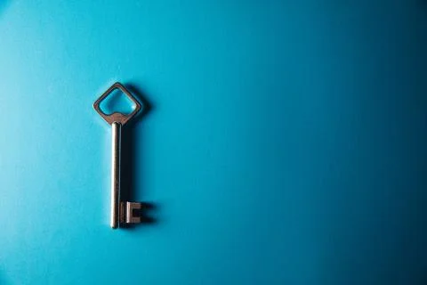 Key on blue background. Minimal creative style Stock Photos