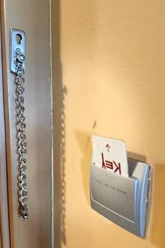 The key card is inserted into a switch in a modern hotel room to turn on the Stock Photos