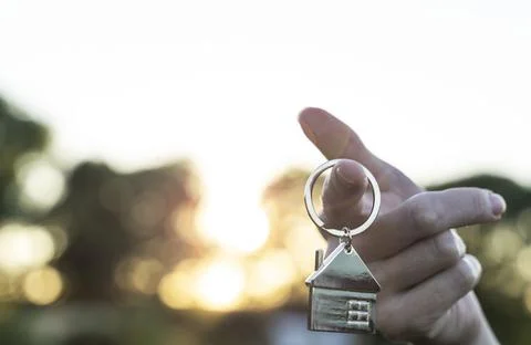 Key chain in the form of a house in your hand of buying a home Stock Photos