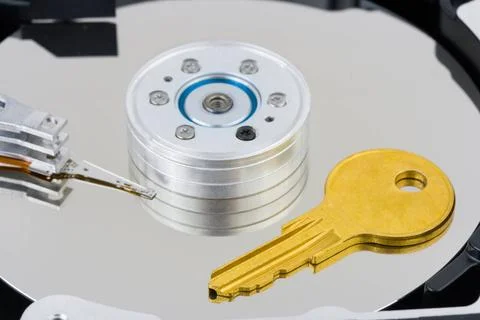 Key on computer disk Key on computer harddrive, security concept backgroun... Stock Photos