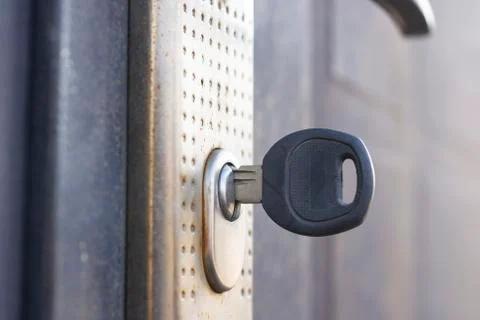 The key in the door lock close-up. Stock Photos